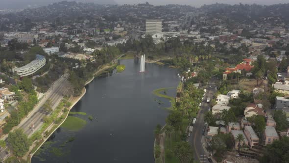 AERIAL: Over Echo Park in Los Angeles, California with Palm Trees, Cloudy 
