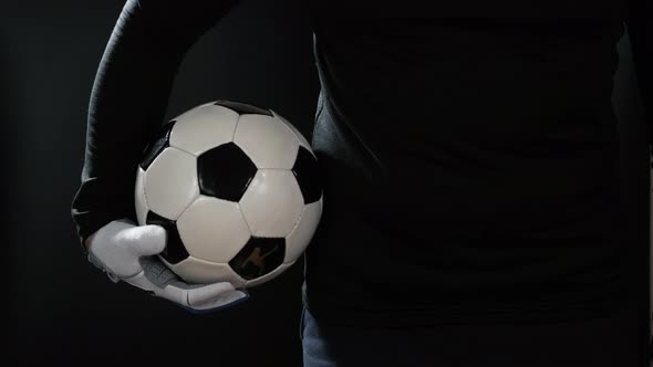 Close Up Goalkeeper Holding Soccer Ball in the Stadium Studio Football Player Hands Professional