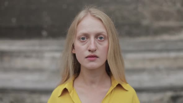 Portrait of Offended Woman Looking To Camera. Close Up View of Sad Unhappy Person with Blue Eyes and