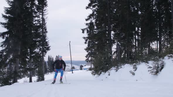 Young woman skiing on a forest trail