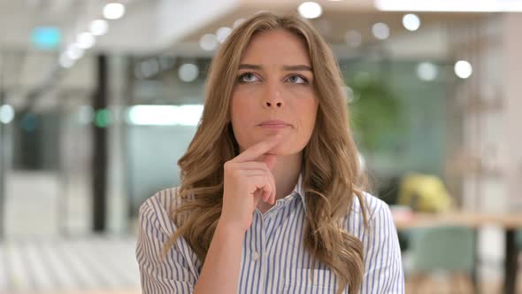 Portrait of Pensive Businesswoman Thinking of Ideas