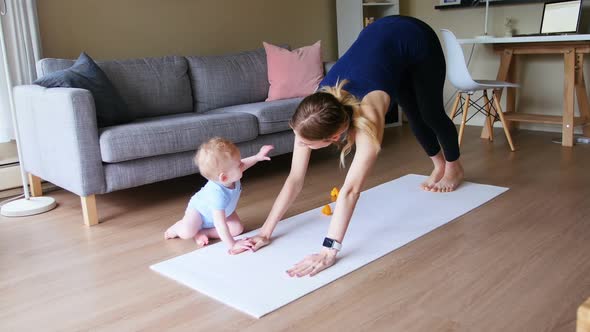 Mother with her baby performing yoga 4k