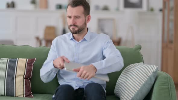 Young Man Closing Laptop Going Away From Sofa 