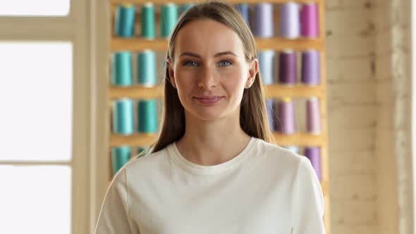 Smiling Pretty Young Woman Looking Into the Camera Posing in a Modern House