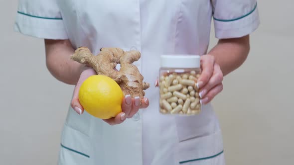 Nutritionist Doctor Healthy Lifestyle Concept - Holding Ginger Root, Lemon and Vitamin Pills