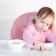 Little baby girl eating and playing with vegetables. Top view - VideoHive Item for Sale