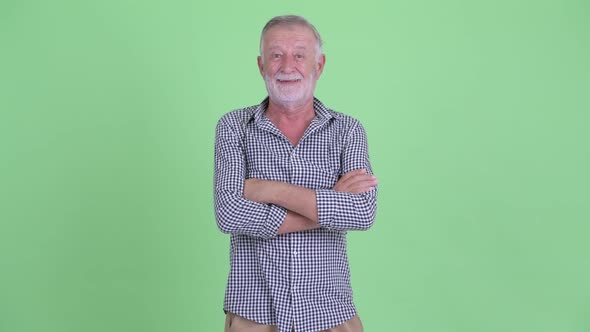 Happy Senior Bearded Man Smiling with Arms Crossed