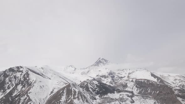 Aerial view of beautiful snowy mountains in Stepantsminda