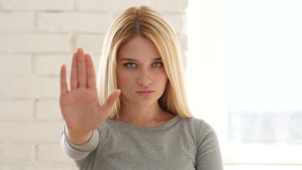 Young Woman Gesturing Stop Sign with Hand