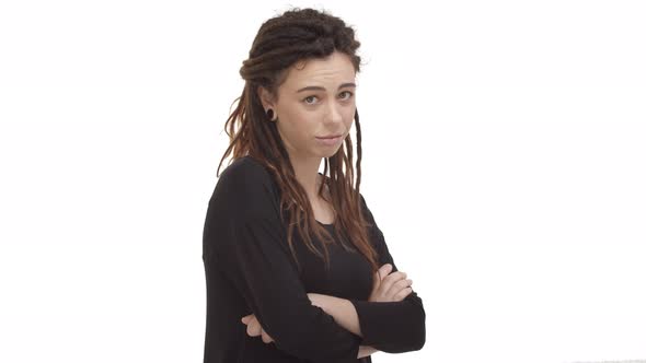 Video of Beautiful Young Woman with Dreadlocks and Ear Tunnels Cross Arms Over Chest and Looking