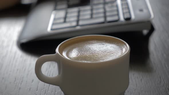 Working place selective focus on coffee cup and keyboard 4K 2160p UHD footage - Typing on keyboard a