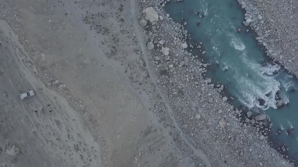 Turquoise River Flowing Through Skardu Valley Floor. Aerial Dolly Back Pedestal Up