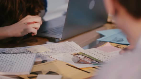 Close-up Shot of Architecture Design Agency Employees Working Together on Project Over Table Full of