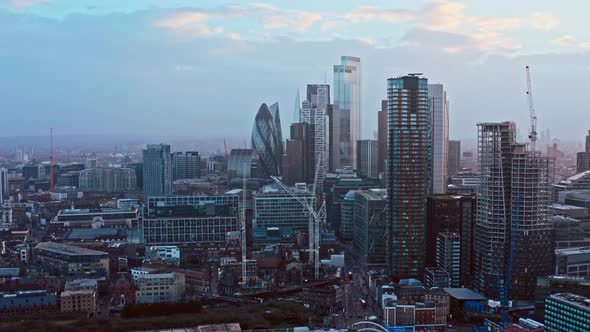 Long dolly back aerial drone shot of skyscrapers in city of London from shoreditch highstreet and ha