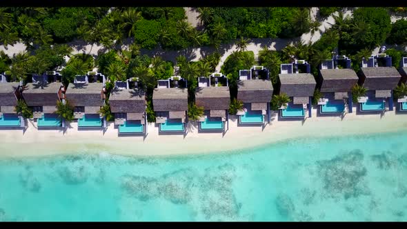 Aerial top down texture of paradise resort beach voyage by blue water and clean sandy background of 