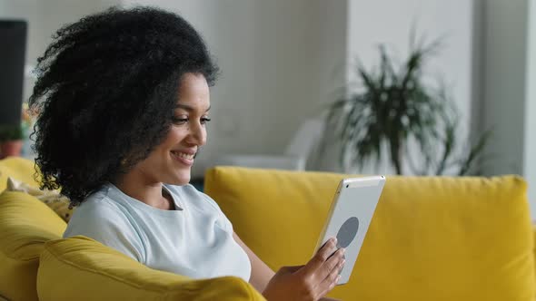 Portrait of a Young African American Woman Talking on a Video Call on Her Digital Tablet