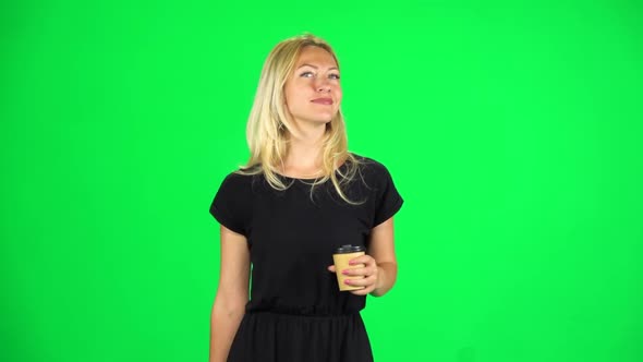 Girl Is Walking and Drinking Coffee From a Paper Cup. Chroma Key. Slow Motion