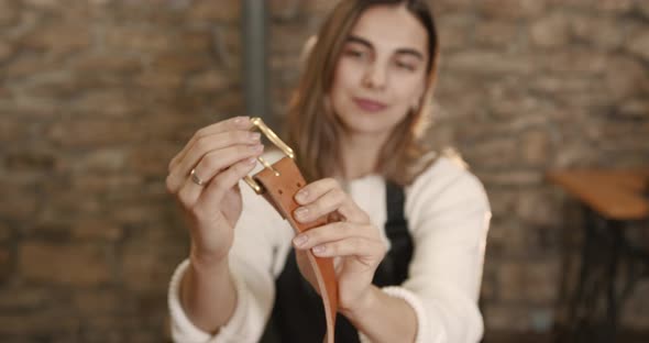 Young Woman Craftsperson Making a Leather Belt