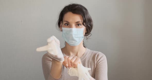 Young Woman Shows How To Wear Protective Medical Mask. Beautiful Girl Shows Protective Mask During