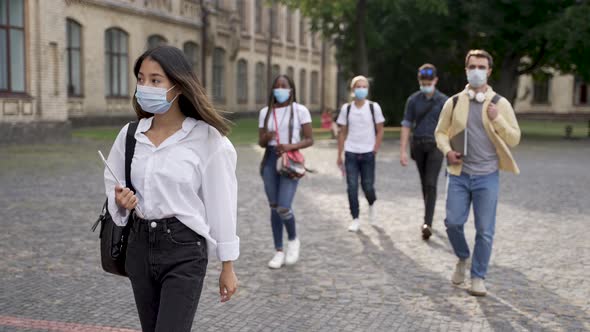 Multiracial Students in Face Masks Going to Class