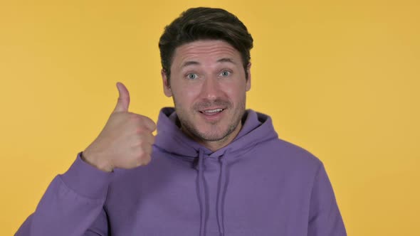 Man with Thumbs Up Yellow Background