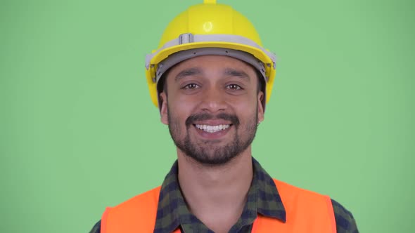 Face of Happy Young Bearded Persian Man Construction Worker Smiling