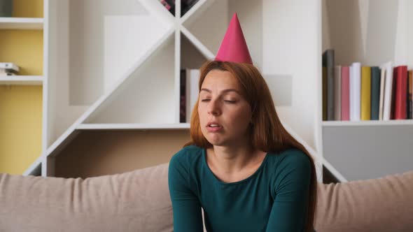 Sad Young Woman Celebrates Birthday Alone in the Living Room