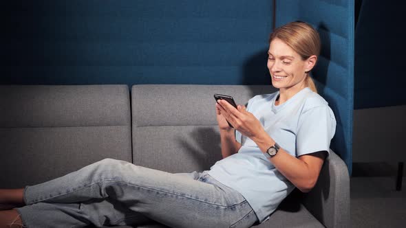 Businesswoman Chatting on Phone in Cozy Sofa