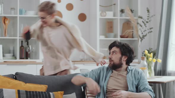 Excited Couple Having Fun at Home