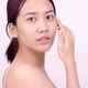 Slow motion of Asian girl with natural make up looking to camera and patting her face gently. - VideoHive Item for Sale