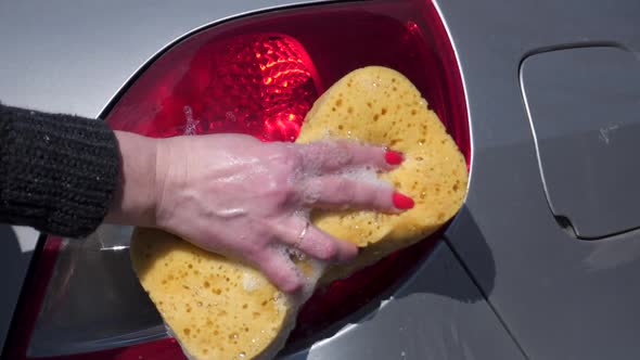 Car wash. Close-up of female hands.