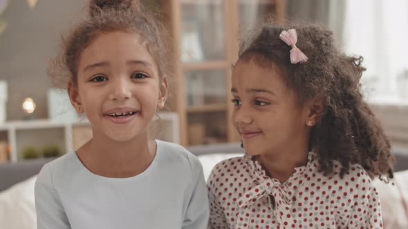 Cute Girl Kissing Sister on Cheek