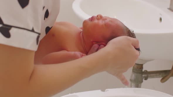 Calm of asian newborn baby bathing in bathtub