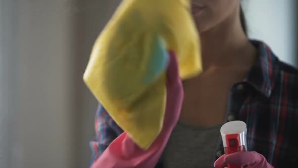 Woman Masterfully Struggling with Stains on Glass Using New Cleaning Agent