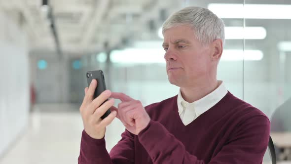 Middle Aged Man Celebrating on Smartphone