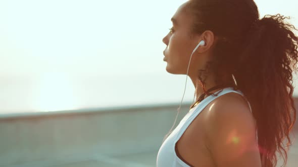 A side view of an attractive african american woman doing sport moving shoulders