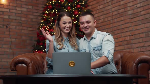 Young Couple Chatting with Relatives Via Webcam