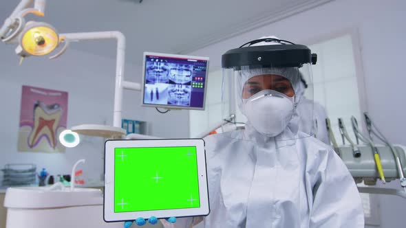 Patient Pov of Dentist in Ppe Suit Pointing on Green Screen