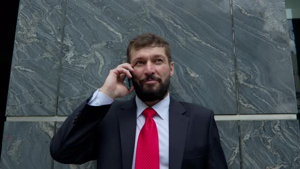 A Man is Talking on a Cell Phone in the Street