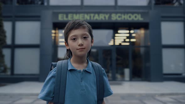 Elementary Age Boy Stand at School Entrance Closeup