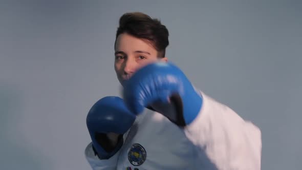 Woman Taekwondo Fighter Trains Shadow Boxing Punches and Kicks