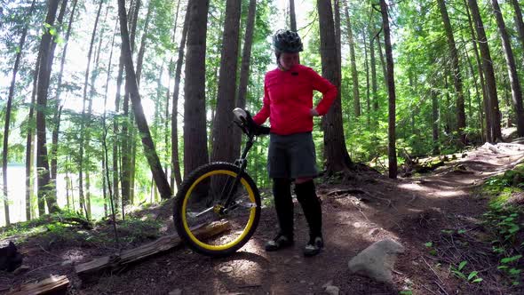 Woman standing with unicycle and using mobile phone