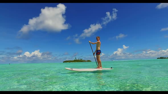 Romantic couple happy together on tropical bay beach trip by clear lagoon with clean sand background