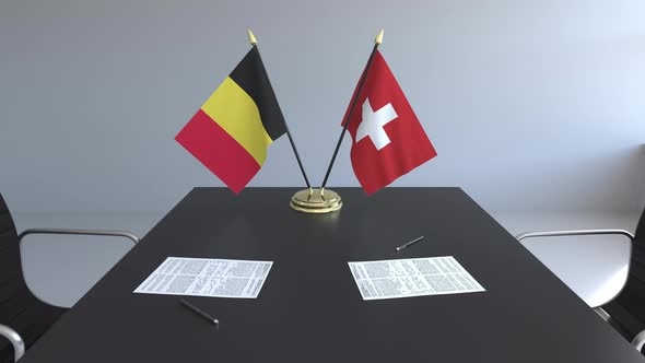 Flags of Belgium and Switzerland and Papers