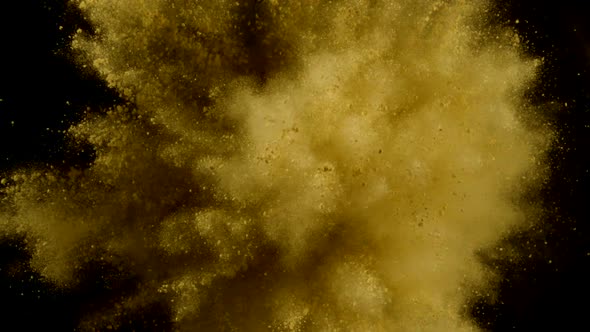 Yellow particles fly after being exploded, Slow Motion