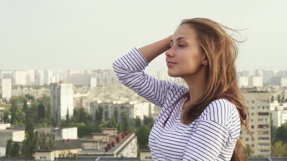 A Girl Enjoys Seeing From the Roof To the City