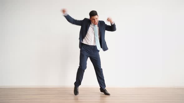 Funny Business Man Dancing for Joy and Success on a White Background