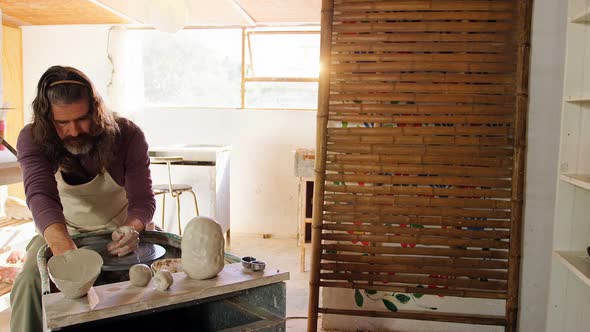 Male potter making pot