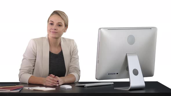 Cheerful Businesswoman Sitting at the Table in Office and Looking at Camera on a Green Screen