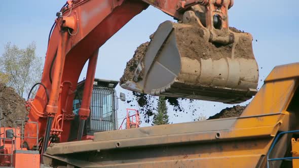 Close-up Red Excavator Loads Tipper Truck